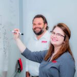 Bailey Vinsant & Matthew Gleeson standing in front of a whiteboard.