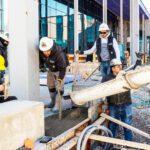 A group of construction workers working on a construction site.