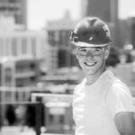 Young construction worker wearing hardhat.